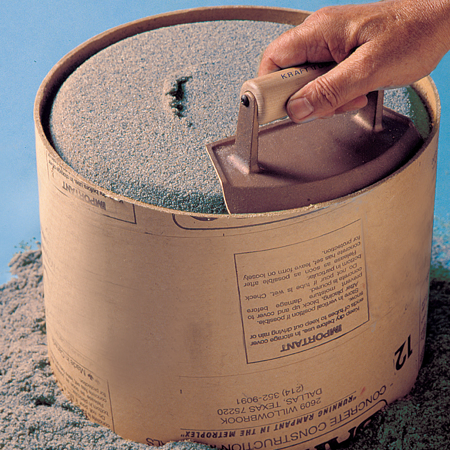 18" Diameter Chamfer Tube Bronze Edger with Wood Handle. The curved bled makes easy movements in a circle. The slope created on the edge can be varied depending on the wetness of hte concrete and the angle and pressure applied. Available from Speedcrete, 