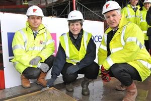 Ordnance Survey official handed commemorative concrete trowel