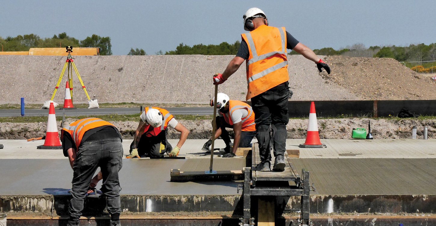 Texturing concrete with a steel broom. Buy these steel brushes from Speedcrete, United Kingdom.